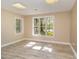Tan-colored bedroom with wood-look flooring and lake views through large windows at 3309 Westcott Cir, Sanford, NC 27330