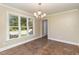Light-filled dining room with brick floors, a chandelier, and a large window at 3309 Westcott Cir, Sanford, NC 27330