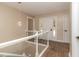 Bright entryway boasts brick floors, a glass panel railing, and a glimpse of the front door at 3309 Westcott Cir, Sanford, NC 27330