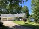 Charming single-story home features a two-car garage, well-manicured lawn, and a serene lake view at 3309 Westcott Cir, Sanford, NC 27330