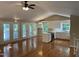Open-concept kitchen and living area featuring white cabinets, stainless steel appliances, and hardwood floors at 3309 Westcott Cir, Sanford, NC 27330