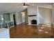 Bright living room with wood floors, vaulted ceiling, and a white brick fireplace at 3309 Westcott Cir, Sanford, NC 27330