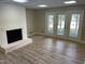 Bright living room with white brick fireplace and patio doors leading to the outside at 3309 Westcott Cir, Sanford, NC 27330