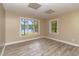 Neutral room with wood-look flooring and views of the lake at 3309 Westcott Cir, Sanford, NC 27330