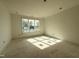 Bright bedroom with light walls and a large window showcasing a well-manicured yard and nearby homes at 2633 Trifle Ln, Wake Forest, NC 27587