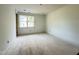 Well-lit bedroom featuring a window with views of the outdoors, ready for customization at 2633 Trifle Ln, Wake Forest, NC 27587