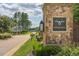 Charming stone community entrance sign with lush greenery, landscaping, and a glimpse of neighborhood homes at 2633 Trifle Ln, Wake Forest, NC 27587