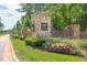 Stone pillar community entrance sign with manicured landscaping, greenery, and flowers at Wexford at 2633 Trifle Ln, Wake Forest, NC 27587