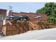 View of a red brick restaurant featuring outdoor seating, a wooden deck and steps at 2633 Trifle Ln, Wake Forest, NC 27587