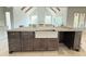 Gourmet kitchen featuring dark wood island with farmhouse sink, pendant lighting, and stainless appliances at 2633 Trifle Ln, Wake Forest, NC 27587