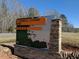 E. Carroll Joyner Park sign with stone base and recreational icons, marking the park entrance at 2633 Trifle Ln, Wake Forest, NC 27587