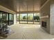 Relaxing screened-in porch featuring a fireplace and views of the landscaped backyard at 2633 Trifle Ln, Wake Forest, NC 27587