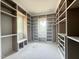 Spacious walk-in closet featuring shelving units, built-in benches, and multiple windows at 2633 Trifle Ln, Wake Forest, NC 27587