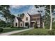 Striking two-story home boasts modern design, clean lines, and lush landscaping, offering curb appeal at 2332 Windy Woods Dr, Raleigh, NC 27607