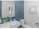 Modern powder room boasts stylish sink, faucet, and fixtures, complemented by a bright window and paint color at 5061 Lundy Dr # 102, Raleigh, NC 27606