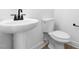 Clean bathroom with pedestal sink and toilet at 329 Roxboro St, Haw River, NC 27258
