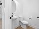 Modern bathroom with pedestal sink and toilet at 329 Roxboro St, Haw River, NC 27258
