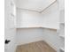 Walk-in closet with shelves and hanging rods at 329 Roxboro St, Haw River, NC 27258