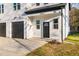 Modern home exterior with black garage doors and a front entry at 329 Roxboro St, Haw River, NC 27258