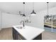 Modern kitchen with white cabinets and a large island at 329 Roxboro St, Haw River, NC 27258
