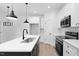 Modern kitchen with white cabinets and a large island at 329 Roxboro St, Haw River, NC 27258