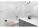 Clean bathroom with gray vanity, tub, and shower at 331 Roxboro St, Haw River, NC 27258