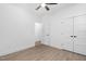 Spacious bedroom with wood flooring, ceiling fan and double doors leading to a possible ensuite at 331 Roxboro St, Haw River, NC 27258