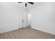 Bedroom with wood flooring, ceiling fan and double doors leading to a possible ensuite at 331 Roxboro St, Haw River, NC 27258