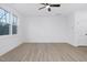 Simple bedroom with large window and light wood flooring at 331 Roxboro St, Haw River, NC 27258