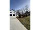Modern farmhouse with black trim and a long concrete driveway at 331 Roxboro St, Haw River, NC 27258