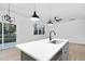 Modern kitchen island with a white countertop and black faucet at 331 Roxboro St, Haw River, NC 27258
