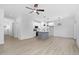Open kitchen with gray island, white cabinets and stainless steel appliances at 331 Roxboro St, Haw River, NC 27258