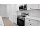 Modern kitchen with stainless steel appliances and white shaker cabinets at 331 Roxboro St, Haw River, NC 27258