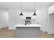 Modern kitchen with white cabinets, gray island, and black pendant lighting at 331 Roxboro St, Haw River, NC 27258
