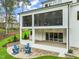 A full back view of the property showcasing the patio, lawn, and screened-in porch at 1621 Legacy Ridge Ln, Wake Forest, NC 27587