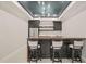 Basement bar area features black cabinetry, butcher block countertop and seating at 1621 Legacy Ridge Ln, Wake Forest, NC 27587