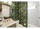 Stylish powder room features floral wallpaper, a modern vanity, and a tiled walk-in shower at 1621 Legacy Ridge Ln, Wake Forest, NC 27587
