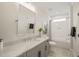 Modern bathroom featuring a large mirror and a combination tub and shower at 1621 Legacy Ridge Ln, Wake Forest, NC 27587