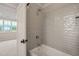Modern bathroom featuring a shower over tub and sleek gray subway tile at 1621 Legacy Ridge Ln, Wake Forest, NC 27587