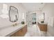 Bright bathroom features marble floors, a floating double vanity, and modern pendant lighting at 1621 Legacy Ridge Ln, Wake Forest, NC 27587