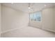 Bright, empty bedroom with neutral carpet, a ceiling fan, and large picture window at 1621 Legacy Ridge Ln, Wake Forest, NC 27587