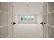Bright and airy bonus room has neutral carpet, a ceiling fan, and four large windows at 1621 Legacy Ridge Ln, Wake Forest, NC 27587