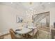 The elegant dining room boasts wood floors, bright lighting, and decorous wall art at 1621 Legacy Ridge Ln, Wake Forest, NC 27587