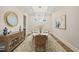 This formal dining area features modern chandelier, wood floors, and stylish décor at 1621 Legacy Ridge Ln, Wake Forest, NC 27587