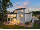 A modern home with white siding, a covered patio, and outdoor seating area at 1621 Legacy Ridge Ln, Wake Forest, NC 27587