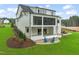 The rear of a modern home with a screened porch, patio, and landscaped yard at 1621 Legacy Ridge Ln, Wake Forest, NC 27587