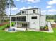 A modern white home featuring a screened porch, patio, and professionally landscaped backyard at 1621 Legacy Ridge Ln, Wake Forest, NC 27587
