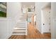 Bright foyer features light wood floors, stairs to the second floor, and an open doorway into another room at 1621 Legacy Ridge Ln, Wake Forest, NC 27587