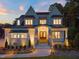 Stunning two-story home featuring brick and stone facade with an inviting arched entryway and professionally landscaped yard at 1621 Legacy Ridge Ln, Wake Forest, NC 27587