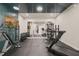 Home gym includes rubber flooring, tv, mirrors, and weightlifting equipment for a complete workout space at 1621 Legacy Ridge Ln, Wake Forest, NC 27587